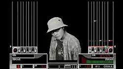 A person wearing a hat is seen at the center of the screen, depicted with monochrome colors over a black background. The left and right sides of the screen contain lanes for notes heading toward the controller's seven keys and turntable. The player's score and groove gauge are at the bottom side of the screen alongside a percentage accounting for the player's overall performance, a red dancer, the song's bpm, "surround", and "0/1 coin(s)".