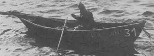 A small wooden dory used for bringing fish back to the Gazela