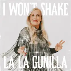 Persson with chest-length blonde hair wearing a shiny silver dress with tassels