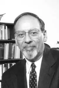 A black and white portrait of Henry Manne