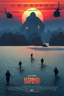 film poster showing Kong towering over mountains with the sun behind him, as well as military soldiers and helicopters slowly approaching towards him.