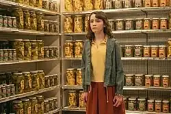 Lilly Bainbridge surrounded by pickle jars while being tormented by Pennywise