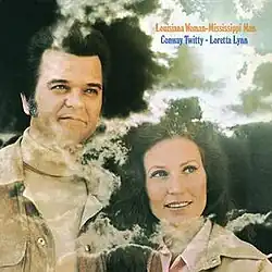 photo of Conway Twitty and Loretta Lynn with clouds and sunlight