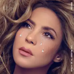 Three jewel tears stream down the face of a blonde Latina woman in make-up. Her lush partially dyed hair frames the border on all sides but the bottom.