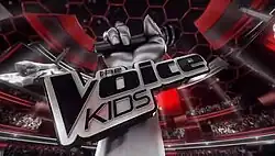 An image of a silver hand holding a microphone in the middle of a venue, with a monitor and dozens of people. The show title is displayed over the wrist.