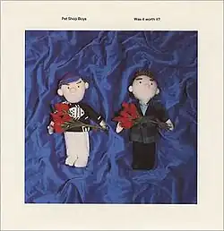 Two male dolls holding red roses on a blue background